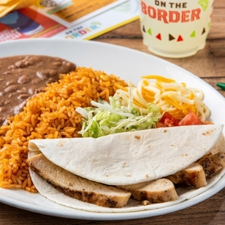 Kids Grilled Chicken Soft Taco Mesquite-grilled chicken in a flour tortilla. Served with mixed cheese, lettuce, tomatoes, Mexican rice and refried beans.