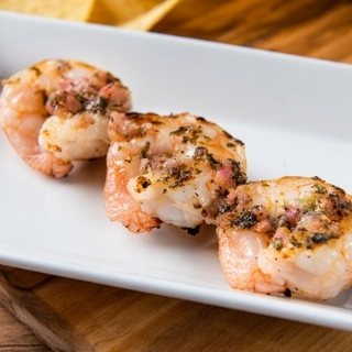Grilled Shrimp Skewer: Grilled Shrimp Skewer, Chipotle Ribs, Jalapeno Sausage: Three shrimp brushed with lime-cilantro chimichurri and grilled over mesquite wood.