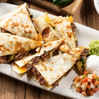 Brisket Quesadilla: Brisket, sautéed onions & pickled jalapeños. Served with jalapeño-BBQ sauce, guacamole, sour cream and pico de gallo.