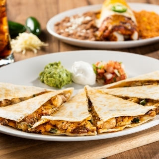 Fajita Quesadilla: Fajita chicken or steak with poblano, onion and roasted red-chile tomatillo salsa. Served with fresh guacamole, sour cream and pico de gallo.