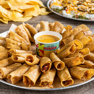 Chicken Flauta Platter: 24 hand-rolled yellow corn tortillas filled with chicken tinga and fried golden. Served with signature queso.