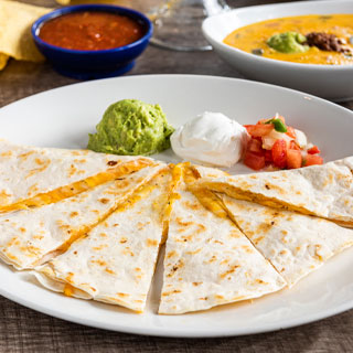 Cheese Quesadilla: A mixed cheese quesadilla served with fresh guacamole, sour cream and pico de gallo.